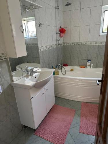 a bathroom with a tub and a sink and a bath tub at Casa Tineretului in Dej