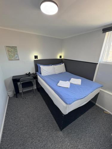 a bedroom with a bed with two towels on it at Alma House in Dover