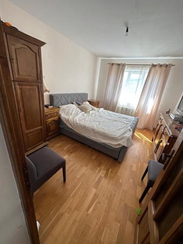 a bedroom with a bed and a desk and a chair at Casa Tineretului in Dej