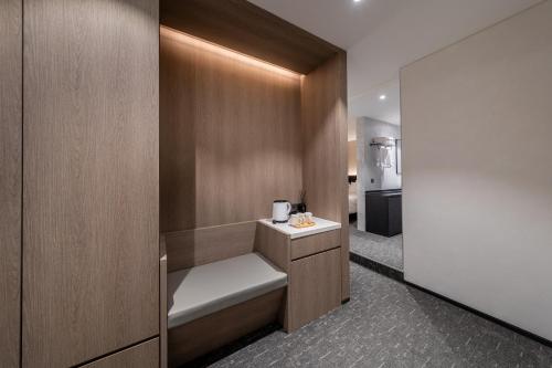 a small bathroom with a bench and a sink at Nesto Hongdae in Seoul