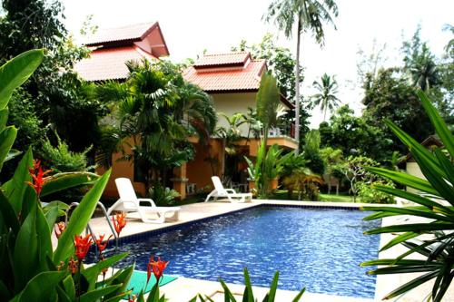 a swimming pool in front of a house at Aonang Lake Side in Ao Nang Beach