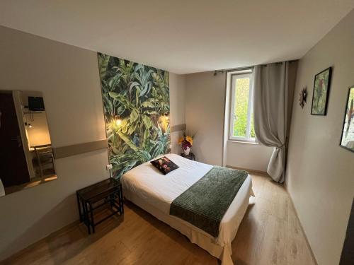 a bedroom with a bed and a large painting on the wall at Auberge Saint Fleuret in Estaing