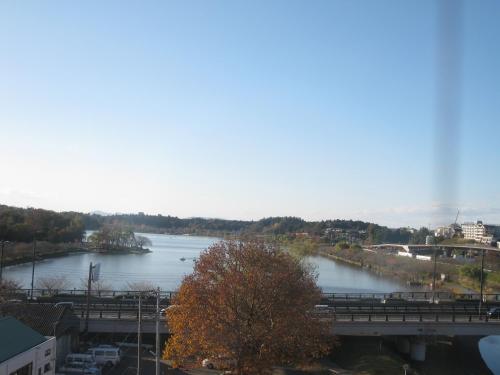a view of a river with a bridge at Mito Riverside Hotel in Mito