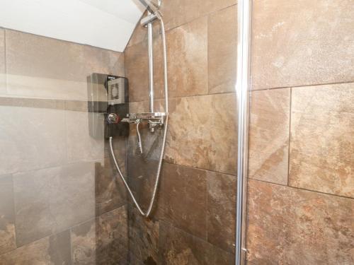 a shower with a glass door in a bathroom at Studio Bach in Beaumaris