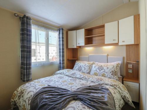 a small bedroom with a bed and a window at Ocean Breeze Escape in Rochester