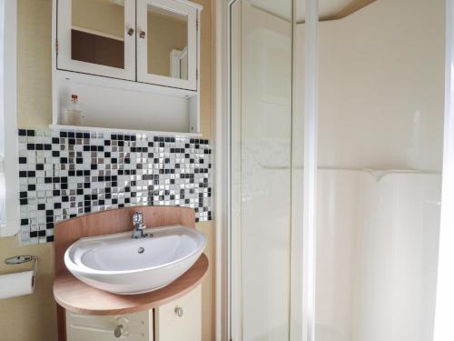 a bathroom with a sink and a shower at Ocean Breeze Escape in Rochester