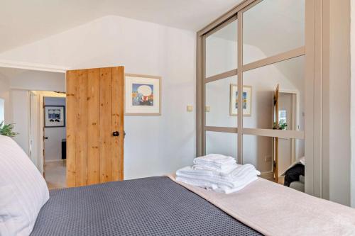 a bedroom with a bed with a large mirror at 3 Bed in Belper oc-o28261 in Belper