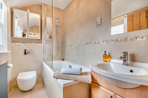 a bathroom with a sink and a tub and a toilet at 3 Bed in Belper oc-o28261 in Belper