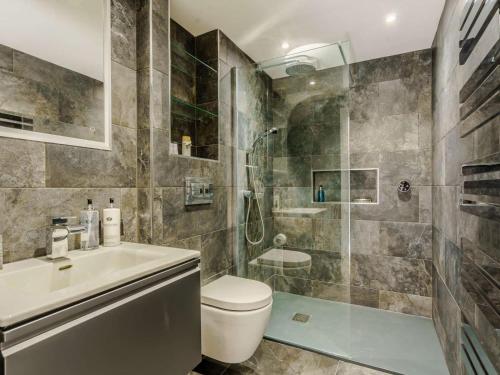 a bathroom with a shower and a toilet and a sink at 2 Bed in Skipton oc-82602 in Buckden