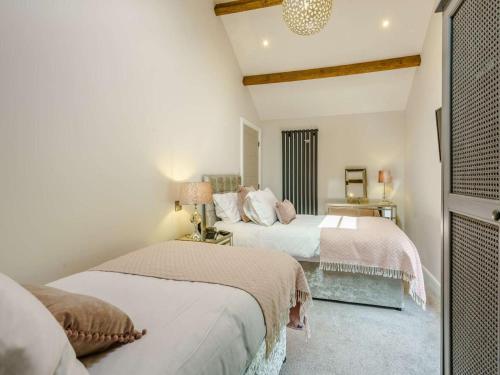 two beds in a room with white walls at 2 Bed in Skipton oc-82602 in Buckden