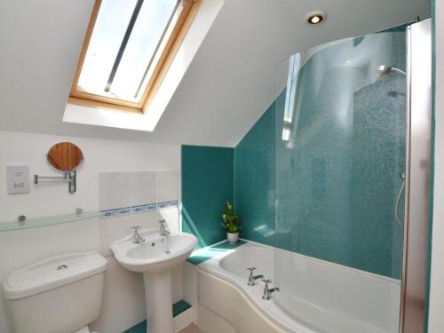 a bathroom with a sink and a toilet and a tub at 4 Bed in Sherborne oc-folow in Long Burton