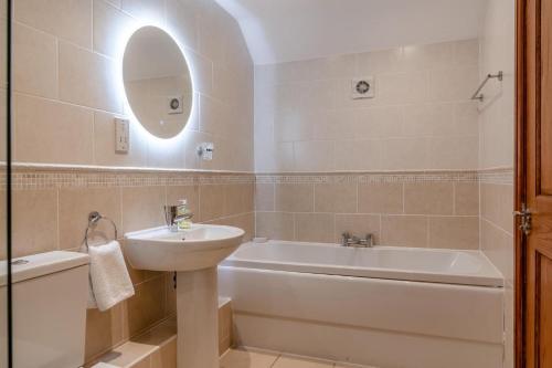 a bathroom with a sink and a bath tub and a sink at 3 Bed in Crakehall oc-m30356 in Crakehall