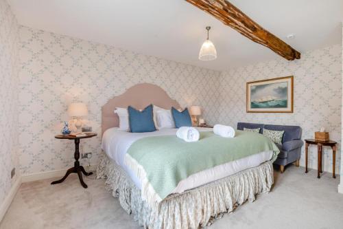 a bedroom with a large bed with blue pillows at 2 Bed in Beaulieu oc-b32274 in Exbury
