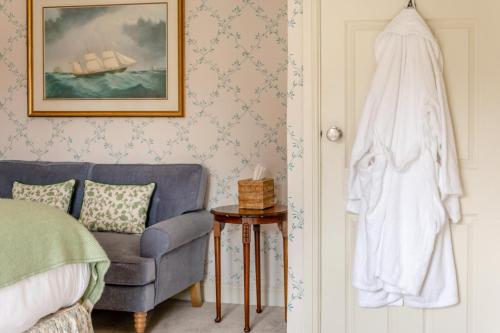 a bedroom with a bed and a chair and a towel at 2 Bed in Beaulieu oc-b32274 in Exbury