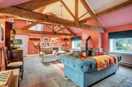 a living room with orange walls and wooden beams at 1 Bed in Crayke oc-g33754 in Crayke