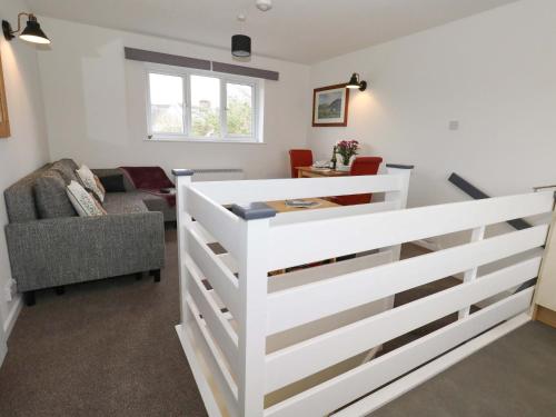 a white fence in a living room with a couch at Amber House in Dorchester