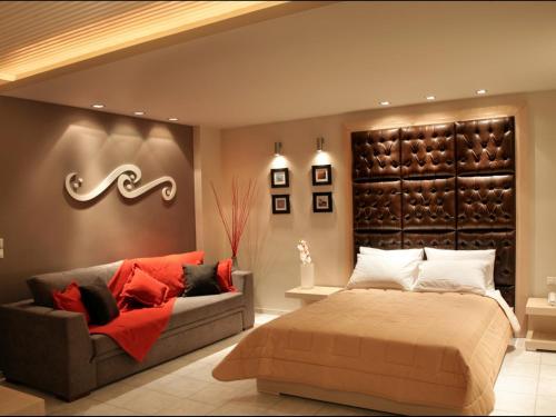 a bedroom with a bed and a couch at Hotel Panorama in Koukounaries