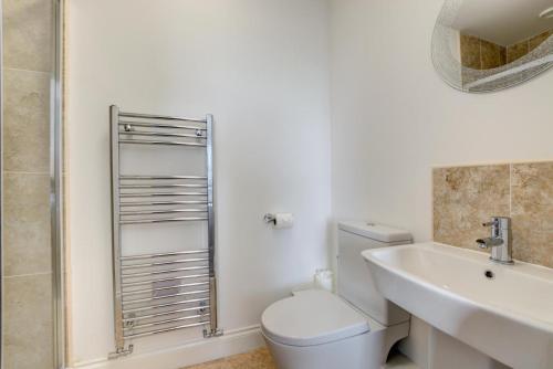 a white bathroom with a toilet and a sink at 4 Bed in Leyburn oc-ds370 in Leyburn