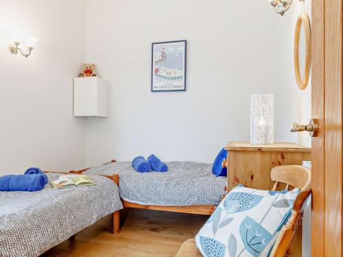 a room with two twin beds and a chair at 2 Bed in Wellington oc-56950 in West Buckland