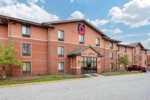 a red brick building with a no sign on it at Studio 6 Extended Stay South Bend Mishawaka South IN in South Bend