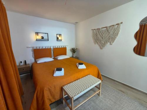 a bedroom with a bed with an orange bedspread at Hotel Korona in Verbovatovka