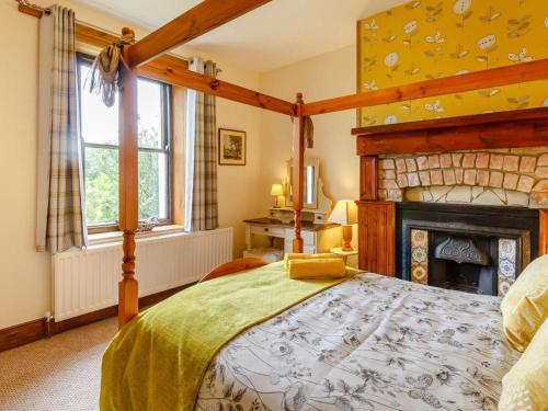 a bedroom with a large bed and a fireplace at 2 Bed in Hexham oc-89086 in Bellingham