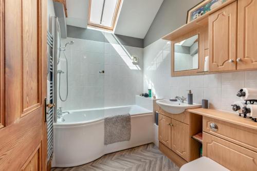 a bathroom with a shower and a tub and a sink at 2 Bed in Belsay oc-t29653 in Bolam