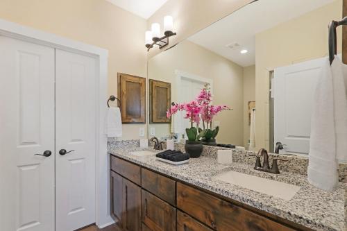 a bathroom with two sinks and a large mirror at The Tipsy Twins - Entire Property in Canyon Lake