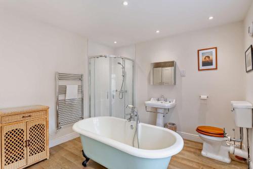 a bathroom with a tub and a shower and a toilet at 3 Bed in Askrigg oc-h29661 in Askrigg