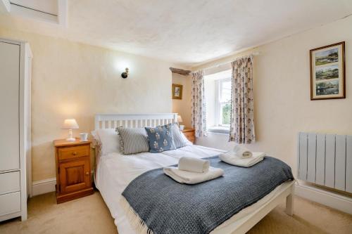 a bedroom with a bed with two towels on it at 1 Bed in Askrigg oc-n28350 in Askrigg