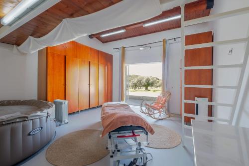 a hospital room with a bed and a table at Monte da Pechincha - Casa de Hóspedes & Spa in Estremoz