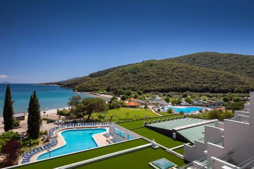 an aerial view of a resort with a swimming pool and a beach at MASLINICA Oliva Camping Pitches in Rabac