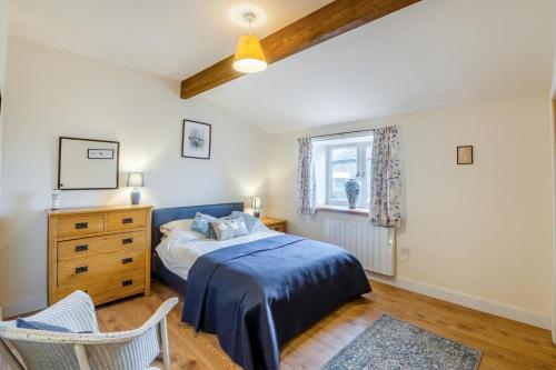 a bedroom with a bed and a dresser and a window at 1 Bed in Middleham oc-c30871 in Gammersgill