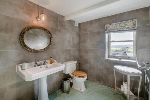 a bathroom with a sink and a toilet and a mirror at 2 Bed in Harmby oc-t30971 in Hornby