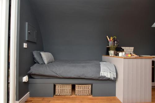 a bed in a room with a wall at 1 Bed in Rocester oc-o33055 in Rocester