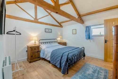 a bedroom with a bed and a wooden floor at 3 Bed in Middleham oc-o32119 in Gammersgill