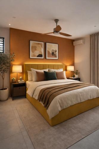 a bedroom with a large bed and two lamps at Fairview Holiday Villa in Rivière Noire