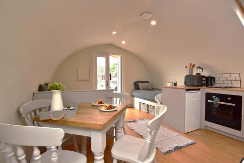 a kitchen and dining room with a table and chairs at 1 Bed in Rocester oc-e33057 in Rocester