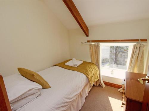 a small bedroom with a bed and a window at 3 Bed in Bamburgh oc-cn222 in Warenford