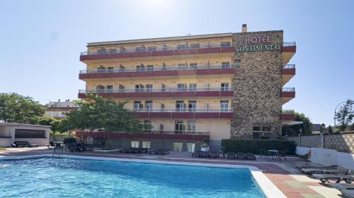 a hotel with a swimming pool in front of a building at BLUESEA Continental in Tossa de Mar
