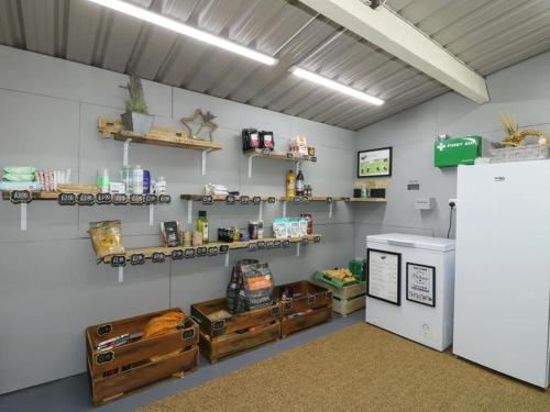 a room with a refrigerator and shelves on the wall at 1 Bed in Rocester oc-w33053 in Rocester