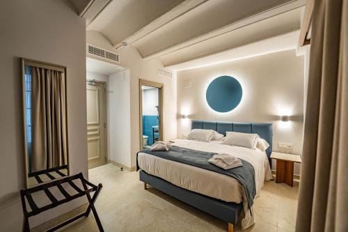 a bedroom with a large bed and a chair at Hotel San Lorenzo Boutique Catedral in Valencia
