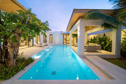 a swimming pool in the backyard of a house at Ming Resort Phuket in Mai Khao Beach