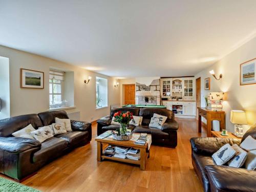 a living room with leather couches and a table at 4 Bed in Rothbury oc-cn180 in Rothbury