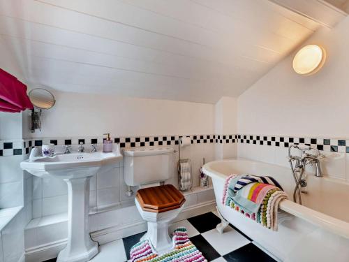 a bathroom with a sink and a tub and a toilet at 4 Bed in Rothbury oc-cn180 in Rothbury