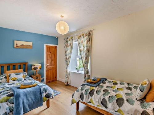 a bedroom with two beds and a window at 4 Bed in Rothbury oc-cn180 in Rothbury