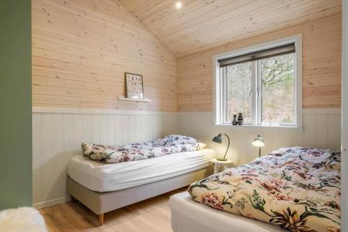 a bedroom with two beds and a window at JB408-Brovst-Urbakken-2 in Brovst