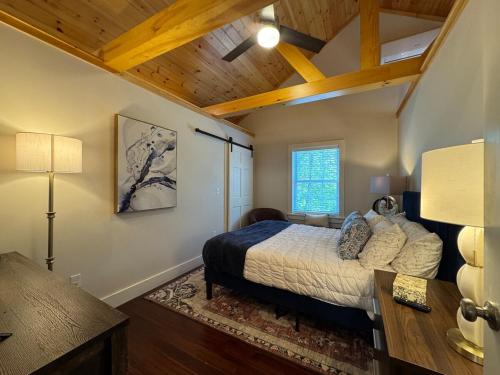 a bedroom with a bed and a wooden ceiling at 3 Bedroom Happy Cottage 15 in Edgecomb