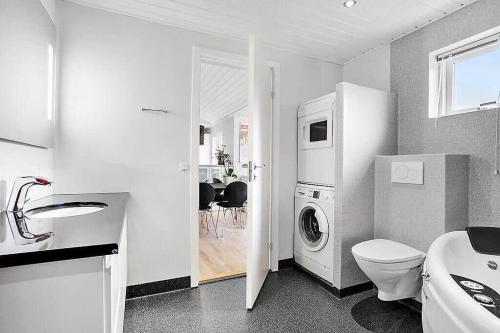 a white bathroom with a washing machine in it at SJ323-Aabenraa-Kloften-14 in Loddenhøj