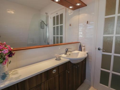 a bathroom with a sink and a mirror at Summerhill in Hereford